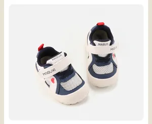Detail of toddler mesh sneakers with white and navy blue design and red accents