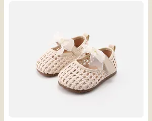 Detailed view of beige woven toddler girls princess shoes with white ribbon bow