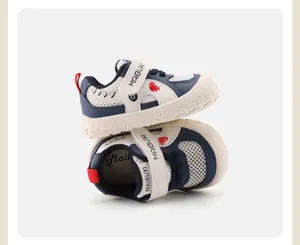 Macro view of navy blue toddler mesh sneakers with white soft soles and Velcro straps.