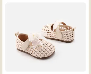 Detail view of cream woven baby girl shoes with elegant bow and soft anti-slip sole