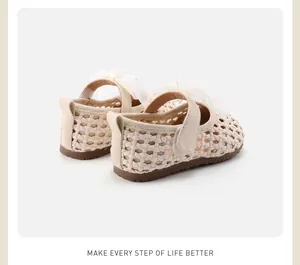 Macro view of cream hollow braided baby girl princess shoes with mesh bow detail