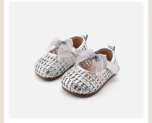 Close-up of silver woven baby princess shoes with delicate grey sheer bow detailing.