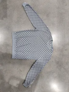 Detailed view of the grey checkerboard jacquard fabric on a men's heavyweight sweatshirt
