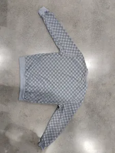 Detailed view of men's grey checkerboard jacquard crewneck sweatshirt with ribbed cuffs