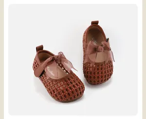 Detailed view of brown woven children's princess shoes with a chiffon bow