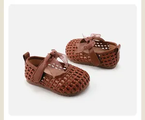 Close-up of brown woven toddler princess shoes with bow detail and hollow design