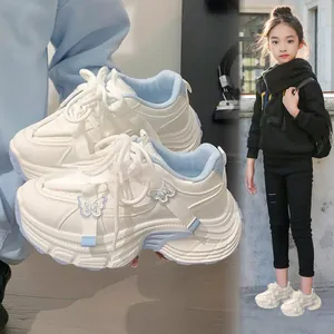 Stylish white butterfly chunky sneakers for girls shown in a trendy lifestyle street setting