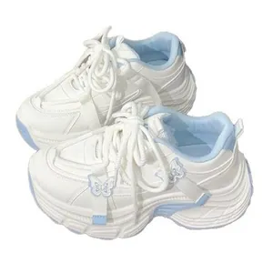 Chunky white platform sneakers for women featuring butterfly charms and light blue accents.