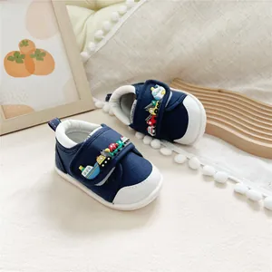 Navy blue baby walking shoes with cartoon vehicle decor and soft rubber soles