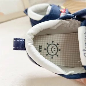 Macro view of baby walking shoe interior showing size 13.0 and smiley face insole