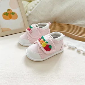 Detail view of pink baby walking shoes featuring soft soles and 3D fruit decorations