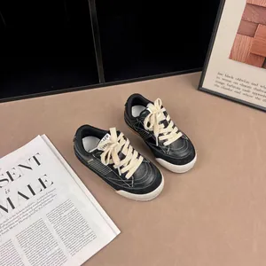Premium retro children's black and white leather sneakers featuring thick cream laces