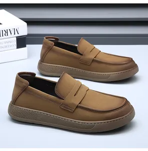 Side view detail of men's brown suede leather loafers with classic penny strap