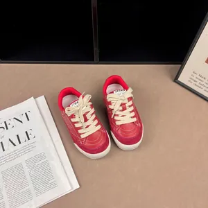 Detailed view of retro red children's leather sneakers featuring soft soles and white laces