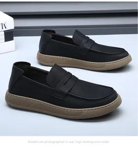 Detail view of black leather loafers with thick tan rubber soles for men's casual wear