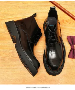 Overhead view of black leather Martin boots with thick soles on a wooden background