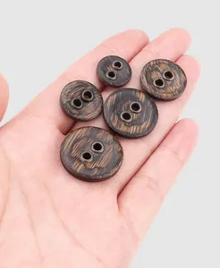 Detailed macro view showing dark ebony wood buttons with reinforced metal eyelets