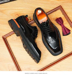 Detailed view of black patent leather brogue shoes with thick soles and wingtip carving