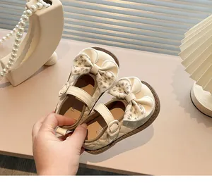 Macro detail view of beige girls' Mary Jane shoes featuring floral bows and quilted patterns