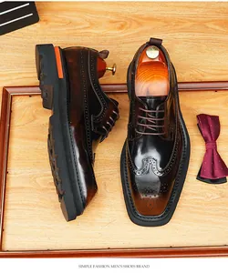 Close-up detail of glossy leather British style Brogue shoes with intricate carving