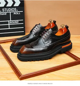 Close-up of glossy brown leather brogue shoes with thick lug soles and orange detail.