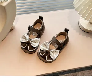 Brown girl's Mary Jane shoes with large floral bow and quilted leather detail