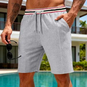Detail of men's quick-dry waffle texture shorts with striped elastic waist.