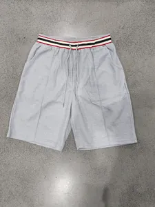 Detail view of men's grey quick-dry athletic shorts with striped waistband and drawstring