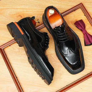 Elegant glossy black leather wingtip brogue dress shoes featuring a sturdy thick lug sole