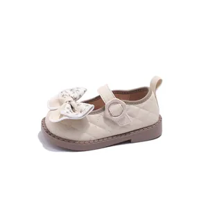 Elegant quilted cream Mary Jane shoes for toddler girls with a pretty floral bow detail.