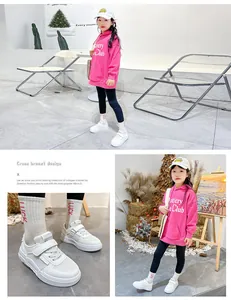 Detail view of white girls' breathable sneakers with Velcro strap and mesh texture.