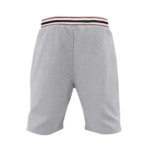 Close-up view of men's grey quick-dry athletic shorts with a striped waistband.