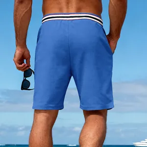 Back view of men's blue quick-dry breathable sports shorts at a sunny beach resort