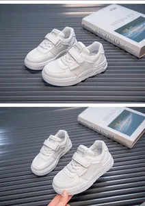 Detail view of white children's sneakers with velcro straps and breathable mesh