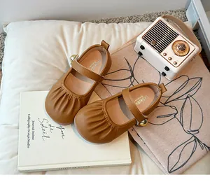 Top view detail of vintage brown girls Mary Jane shoes with unique pleated toe design