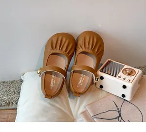 Close-up of brown toddler Mary Jane shoes with ruffled detail and soft sole