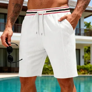 Detailed close-up of men's white summer vacation shorts with striped drawstring waist
