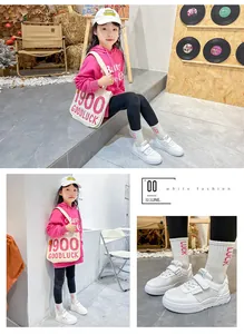 Detailed view of girls' white sneakers with soft soles in a lifestyle setting