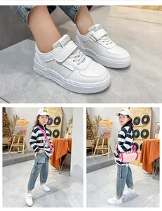 Detailed close-up and model fit of stylish white children's sports shoes for boys and girls.