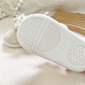 Close-up of non-slip soft sole on baby walking shoes showing texture and size 13.0