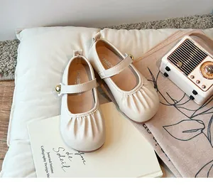Detailed view of cream beige Mary Jane princess shoes for girls with soft pleated toe design