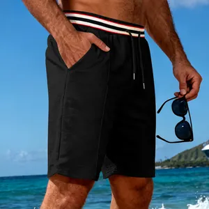 Close-up of the honeycomb breathable fabric and striped waistband on men's black shorts.