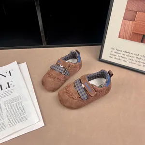 Close-up view of brown toddler mesh casual sneakers with blue checkered velcro strap design