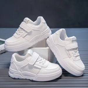 Detailed view of white breathable mesh children's sneakers with hook-and-loop straps.