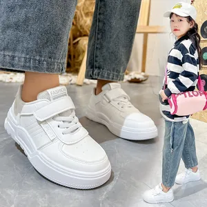 Close-up and lifestyle view of stylish white kids' fashion sneakers with soft soles