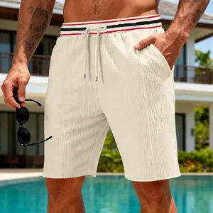 Close-up of men's quick-dry sports shorts with textured fabric in a poolside setting
