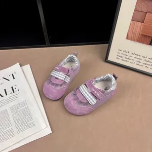 Detail view of purple toddler sneakers with checkered straps and soft mesh