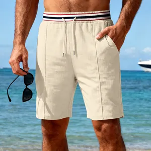 Detailed close-up of men's beige waffle-knit casual shorts with striped waistband for summer