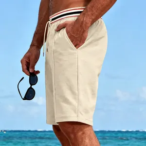 Side view of cream breathable quick-dry men's casual shorts on a sunny beach background