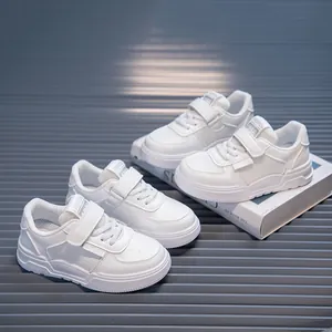 Detail showing breathable mesh and faux leather panels on these kids' white sneakers